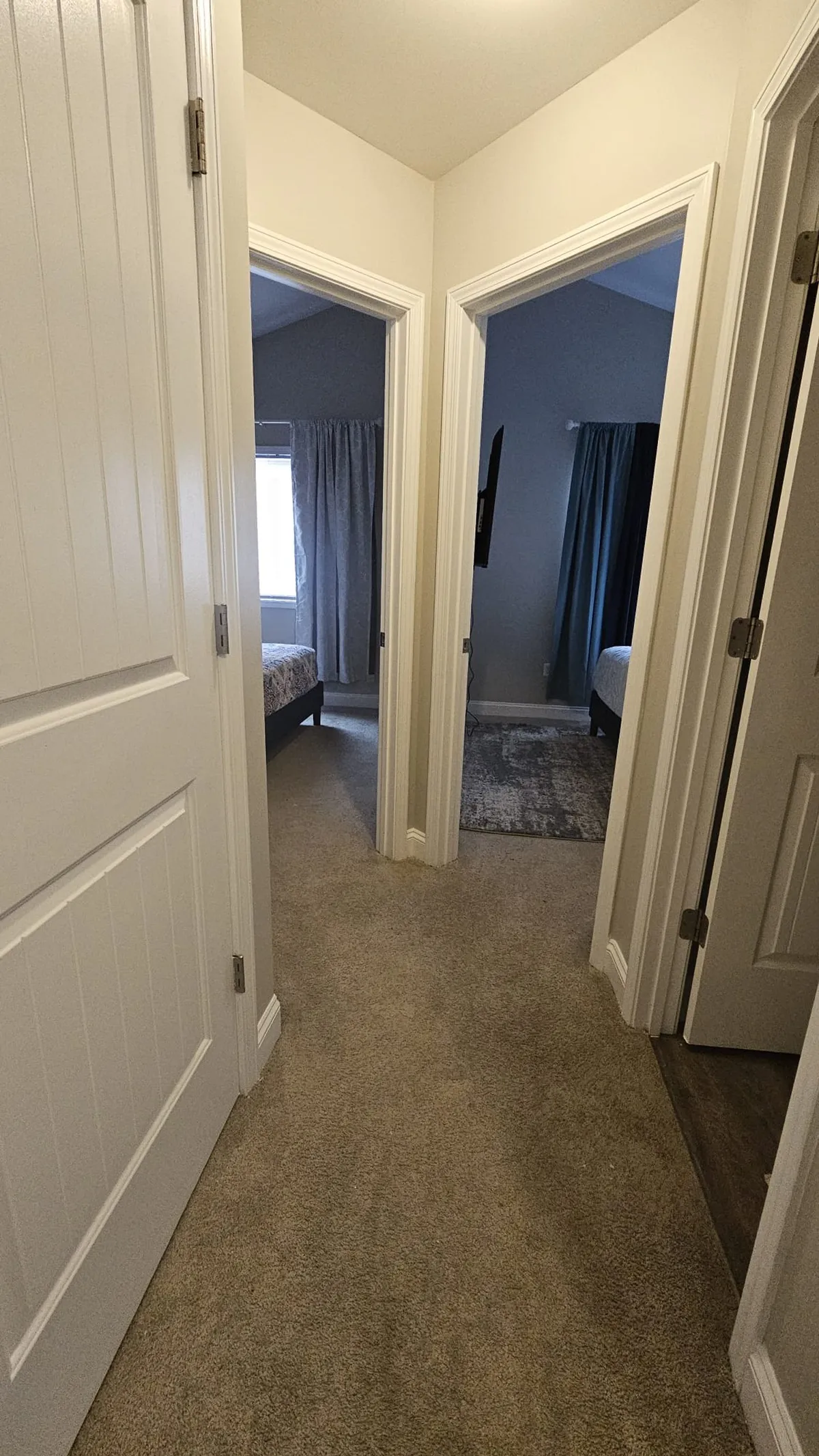 A calm interior hallway with bedroom doors and a soft carpeted floor, inviting relaxation and quiet moments. The space feels distinctly private and personal, reinforcing the comfort and seclusion of the home’s interior.
